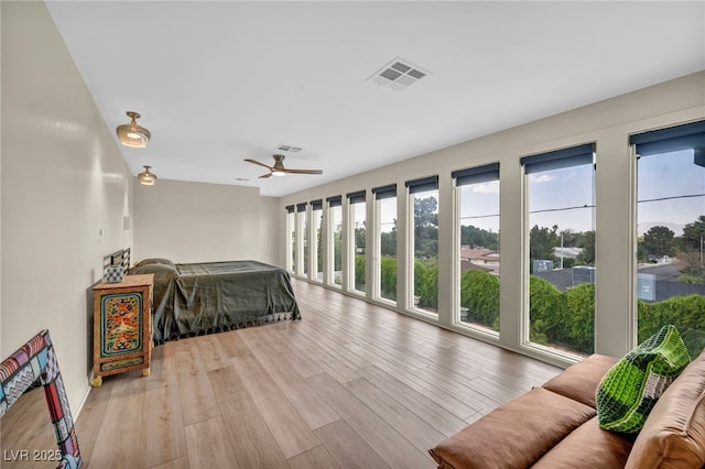 bedroom featuring wood finished floors, ceiling fan, and access to exterior