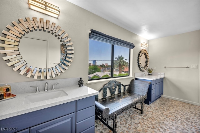 bathroom with two vanities and baseboards