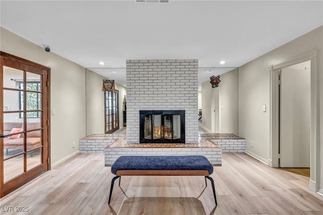 living area featuring light wood-type flooring, healthy amount of natural light, baseboards, and recessed lighting
