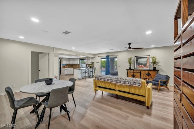 dining space with recessed lighting, light wood-style floors, ceiling fan, and baseboards