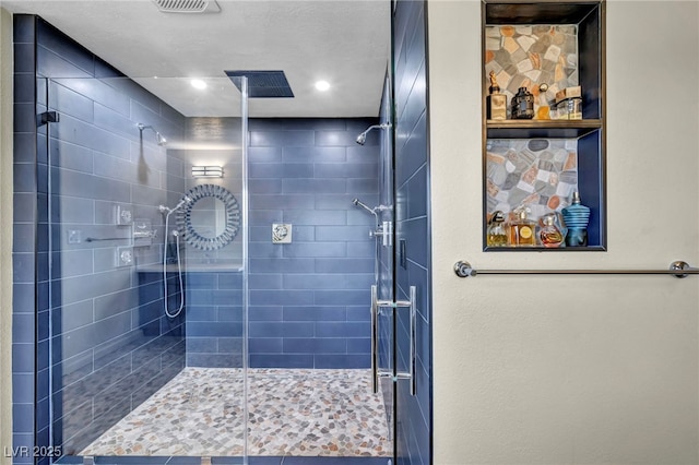 bathroom with a stall shower and recessed lighting