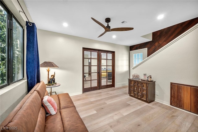 living area featuring french doors, a ceiling fan, wood finished floors, recessed lighting, and baseboards