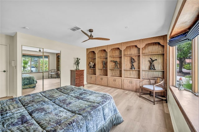 bedroom featuring wood finished floors, a ceiling fan, and access to exterior