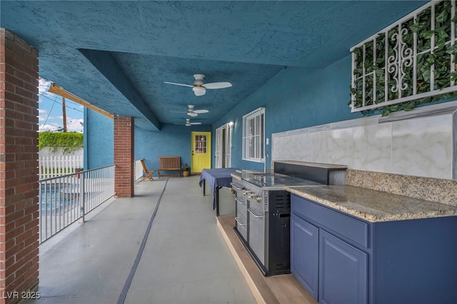 view of patio / terrace with an outdoor kitchen, a ceiling fan, and fence