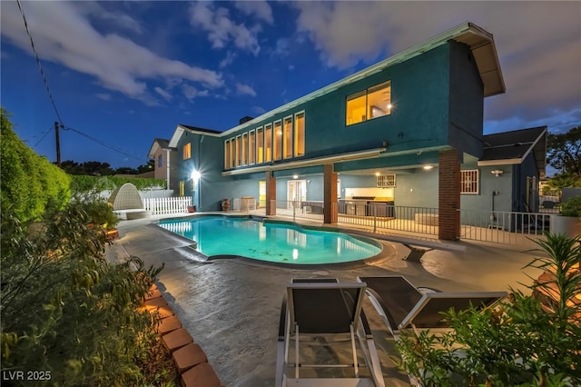 swimming pool featuring a patio and fence