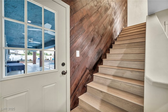 stairs featuring wooden walls