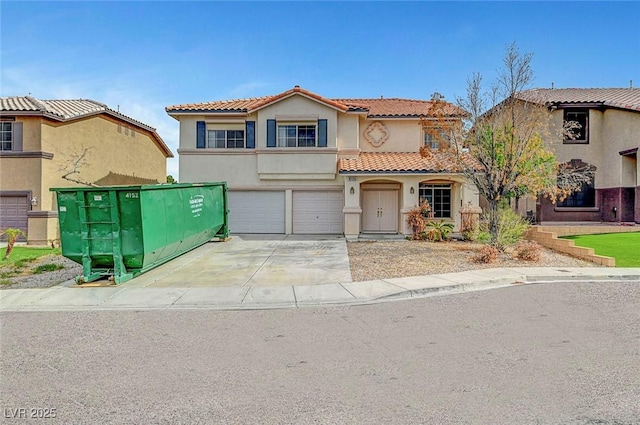 10135 Diving Duck Ave, Las Vegas, NV 89117 - view of front of house with driveway, a tile roof, stucco siding, and a garage