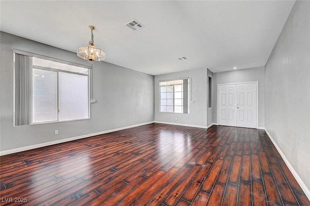 10135 Diving Duck Ave, Las Vegas, NV 89117 - empty room featuring a chandelier, wood finished floors, and baseboards