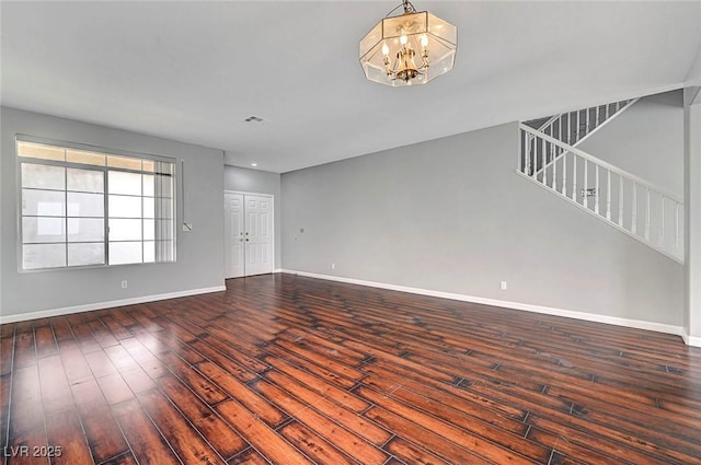 10135 Diving Duck Ave, Las Vegas, NV 89117 - unfurnished living room featuring baseboards, a chandelier, hardwood / wood-style floors, and stairway