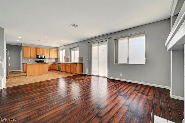 10135 Diving Duck Ave, Las Vegas, NV 89117 - unfurnished living room featuring light wood-style flooring, baseboards, and recessed lighting