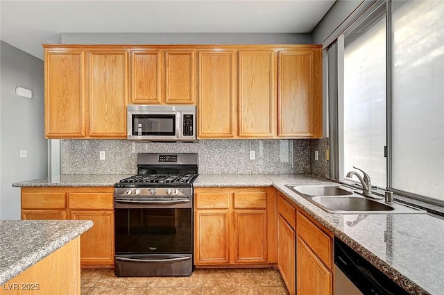 10135 Diving Duck Ave, Las Vegas, NV 89117 - kitchen featuring appliances with stainless steel finishes, a sink, tasteful backsplash, and light stone countertops