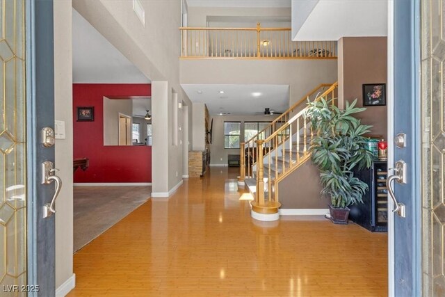 8723 Melissa Meadows St, Las Vegas, NV 89131 - foyer featuring stairway, baseboards, a ceiling fan, and wood finished floors