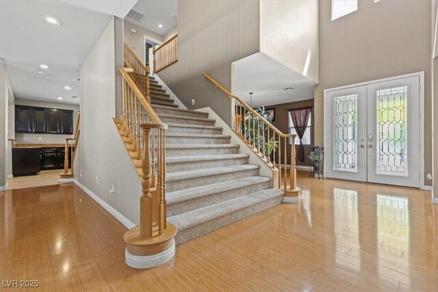 8723 Melissa Meadows St, Las Vegas, NV 89131 - foyer with a high ceiling, hardwood / wood-style flooring, baseboards, french doors, and stairway