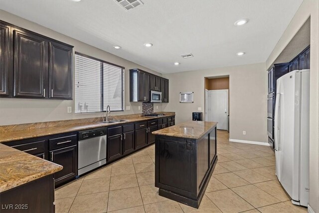 8723 Melissa Meadows St, Las Vegas, NV 89131 - kitchen with appliances with stainless steel finishes, a sink, a center island, light tile patterned floors, and recessed lighting