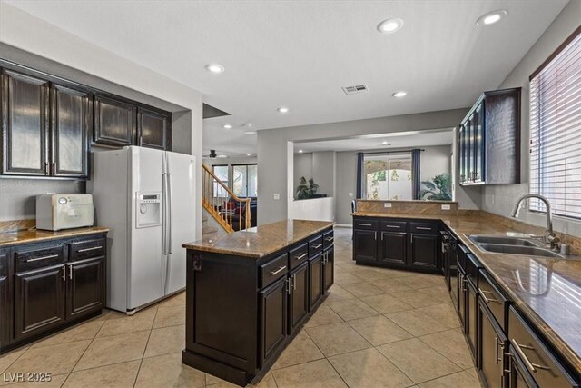 8723 Melissa Meadows St, Las Vegas, NV 89131 - kitchen with white refrigerator with ice dispenser, a sink, light tile patterned floors, dark stone counters, and recessed lighting