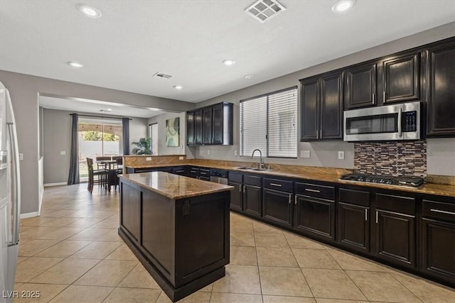 8723 Melissa Meadows St, Las Vegas, NV 89131 - kitchen with stainless steel appliances, a sink, light tile patterned floors, recessed lighting, and a kitchen island