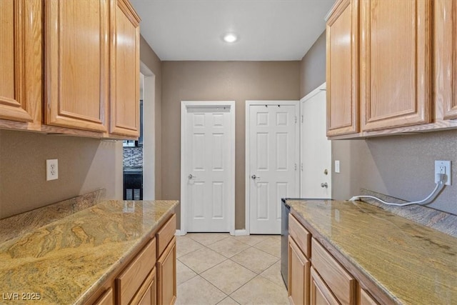 8723 Melissa Meadows St, Las Vegas, NV 89131 - kitchen with light tile patterned flooring, light stone counters, and baseboards