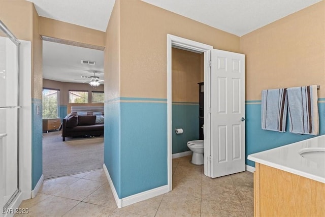 8723 Melissa Meadows St, Las Vegas, NV 89131 - ensuite bathroom with tile patterned floors, toilet, a ceiling fan, baseboards, and an enclosed shower