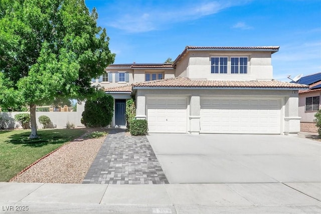 6313 Giant Oak St, North Las Vegas, NV 89084 - mediterranean / spanish house featuring stucco siding, concrete driveway, a tile roof, and a garage