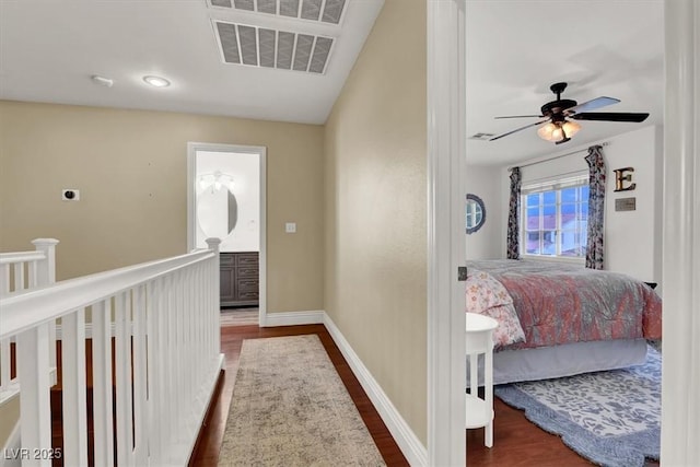 10046 Floragold Ct, Las Vegas, NV 89147 - hall featuring wood finished floors, baseboards, and an upstairs landing
