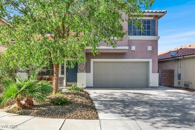 10046 Floragold Ct, Las Vegas, NV 89147 - view of front of home featuring a garage, stucco siding, and driveway