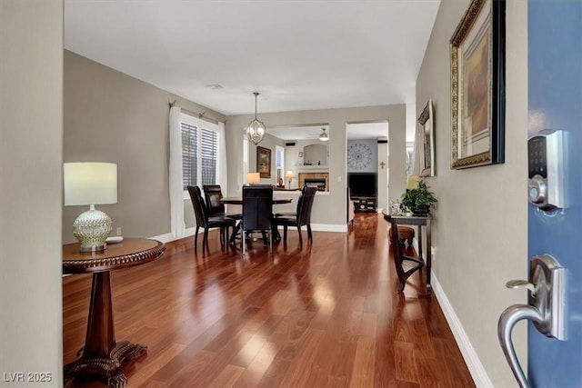 10046 Floragold Ct, Las Vegas, NV 89147 - dining area with dark wood finished floors, ceiling fan, and baseboards
