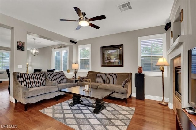 10046 Floragold Ct, Las Vegas, NV 89147 - living area with healthy amount of natural light, baseboards, wood finished floors, and a chandelier