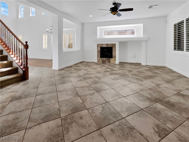 10056 Cranbrook Falls Ct, Las Vegas, NV 89148 - unfurnished living room with tile patterned flooring, a tile fireplace, plenty of natural light, stairs, and recessed lighting