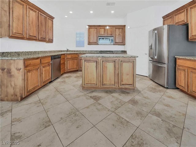 10056 Cranbrook Falls Ct, Las Vegas, NV 89148 - kitchen featuring stainless steel appliances, brown cabinetry, and recessed lighting