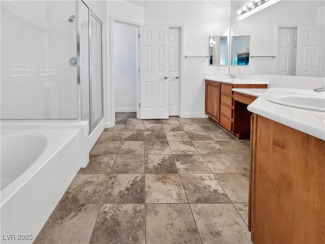 10056 Cranbrook Falls Ct, Las Vegas, NV 89148 - full bath featuring a shower stall, double vanity, stone finish flooring, a garden tub, and baseboards