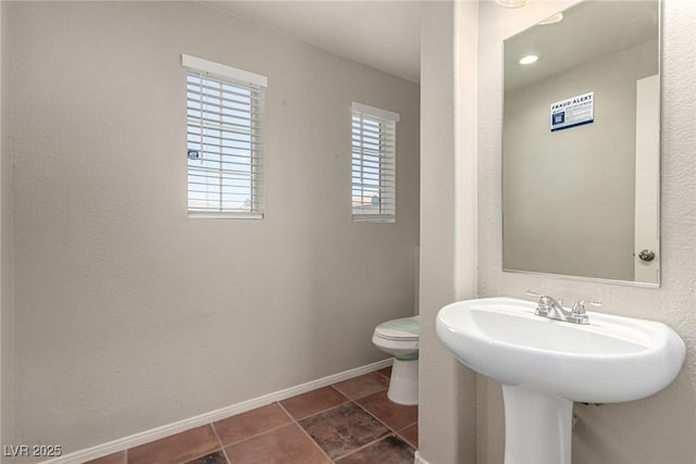 4705 Delicate Arch Ct, North Las Vegas, NV 89031 - half bath featuring toilet, tile patterned flooring, and baseboards