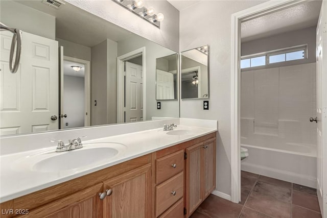 4705 Delicate Arch Ct, North Las Vegas, NV 89031 - full bath featuring double vanity, toilet, and tile patterned flooring