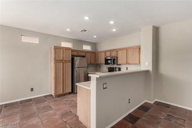 4705 Delicate Arch Ct, North Las Vegas, NV 89031 - kitchen with stainless steel appliances, light countertops, a peninsula, baseboards, and recessed lighting