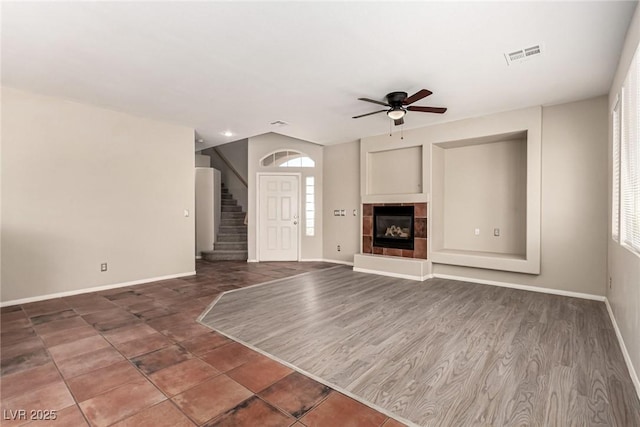4705 Delicate Arch Ct, North Las Vegas, NV 89031 - unfurnished living room with ceiling fan, baseboards, and stairs
