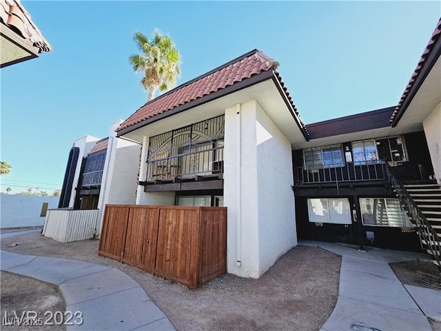 1405 Vegas Valley Dr Unit 380, Las Vegas, NV 89169 - view of side of property featuring a tiled roof and stucco siding