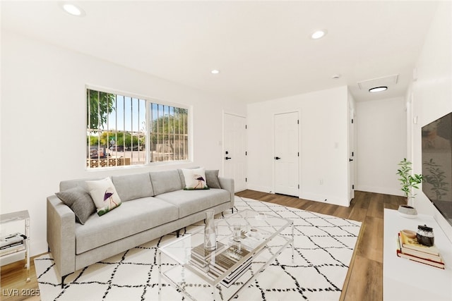 living room with recessed lighting, wood finished floors, and baseboards