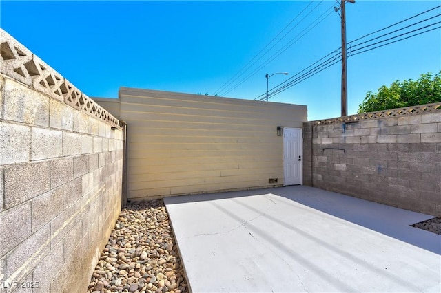 view of patio featuring fence