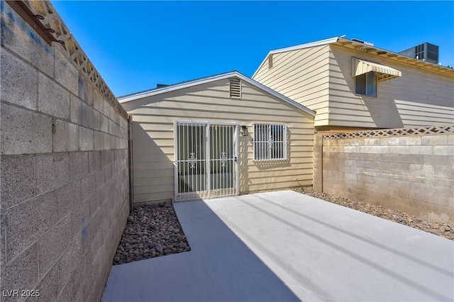 rear view of house with a patio and fence