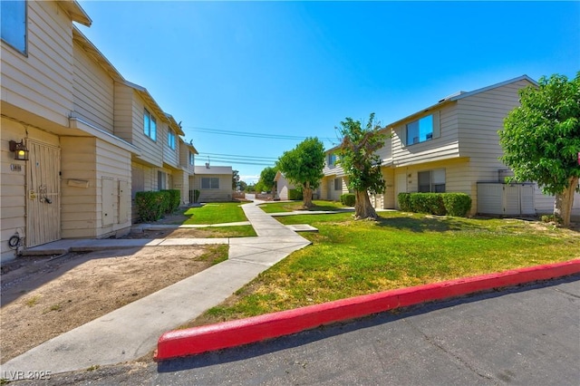 view of green lawn with a residential view