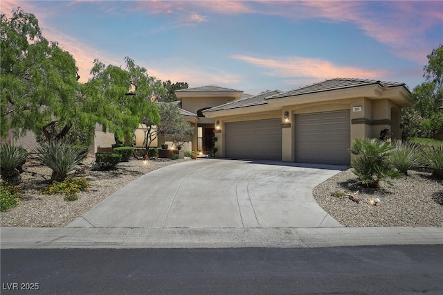 304 Cambrian Ridge Ct, Las Vegas, NV 89144 - view of front of home featuring an attached garage, concrete driveway, stucco siding, and a tile roof