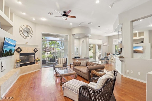 304 Cambrian Ridge Ct, Las Vegas, NV 89144 - living room featuring ceiling fan, a tile fireplace, recessed lighting, and wood finished floors