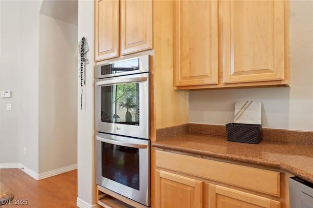 304 Cambrian Ridge Ct, Las Vegas, NV 89144 - kitchen with stainless steel appliances, light brown cabinets, light wood-style floors, and baseboards