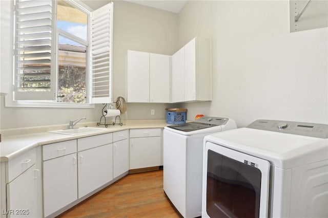 304 Cambrian Ridge Ct, Las Vegas, NV 89144 - clothes washing area with washer and dryer, plenty of natural light, light wood-type flooring, and cabinet space