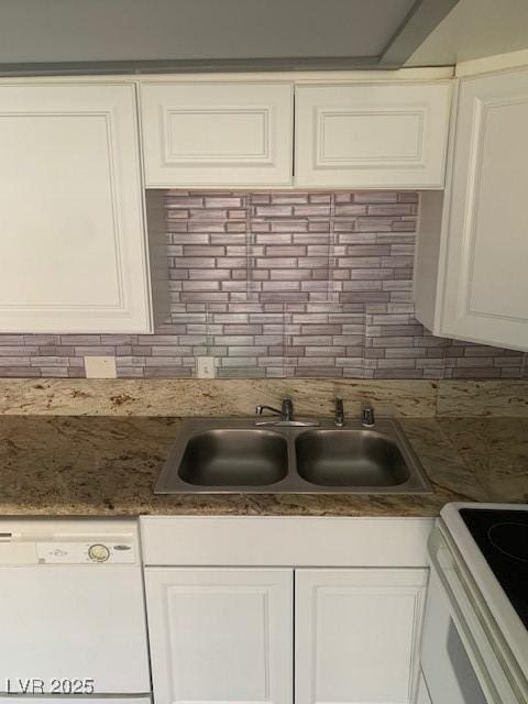 kitchen featuring dishwasher, backsplash, a sink, white cabinetry, and range