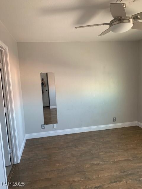 spare room with ceiling fan, wood finished floors, and baseboards