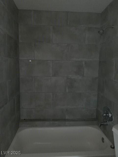 bathroom featuring  shower combination and toilet