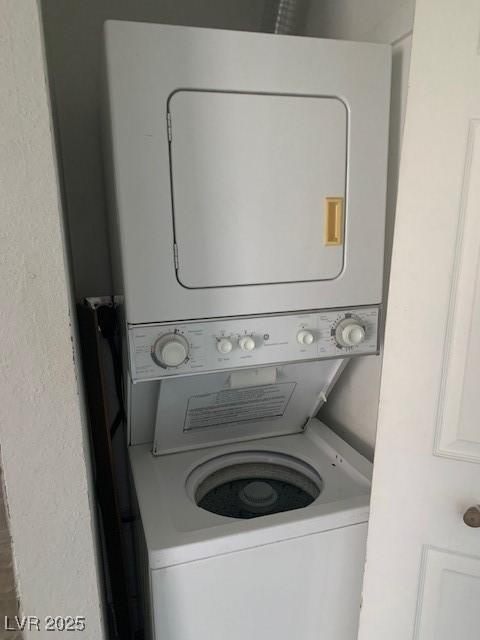 laundry area with stacked washing machine and dryer