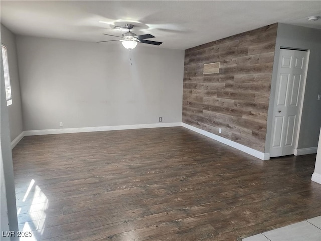 4300 N Lamont St Unit 249, Las Vegas, NV 89115 - unfurnished room featuring a ceiling fan, wood walls, dark wood-type flooring, and baseboards