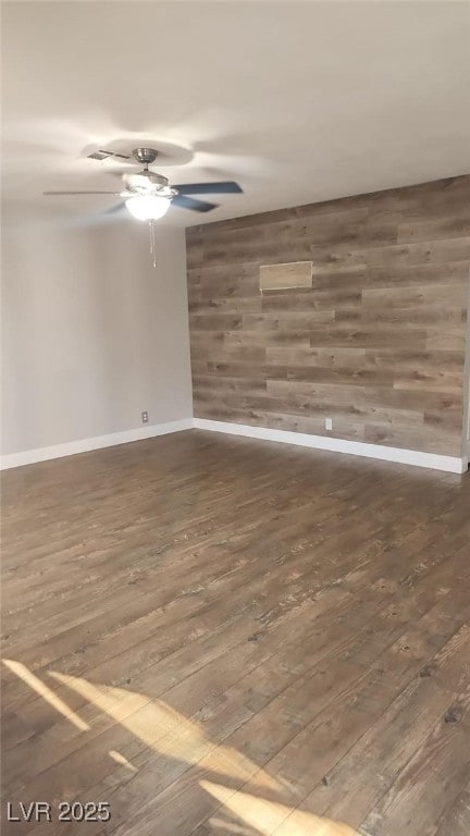 4300 N Lamont St Unit 249, Las Vegas, NV 89115 - empty room featuring a ceiling fan, hardwood / wood-style flooring, wooden walls, and baseboards
