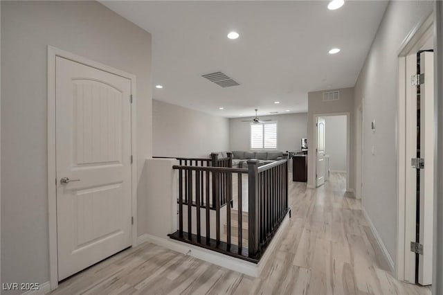 205 Piedmont Alps St, Henderson, NV 89012 - hall featuring light wood finished floors, an upstairs landing, recessed lighting, and baseboards